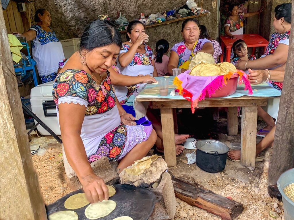 Maya women cooking tortillas in a traditional way.