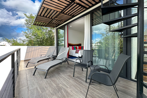 Private terrace with lounge chairs and spiral staircase at Casa Debra.