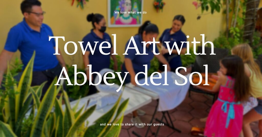 Abbey del Sol staff teaching young guests how to create towel art in a vibrant garden setting.