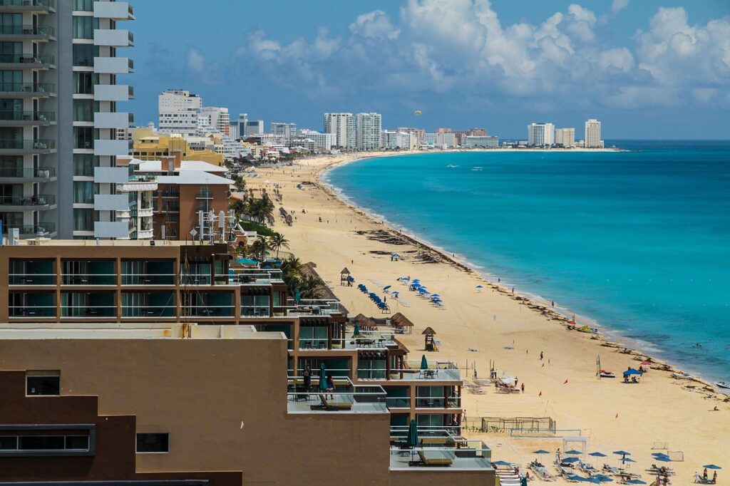 A panoramic view of Cancun’s beachfront with high-rise buildings and turquoise waters
