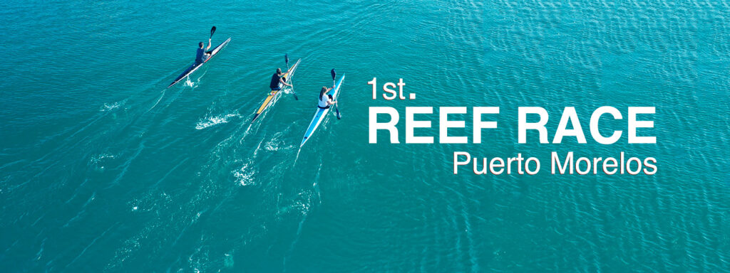 Three kayakers racing across the turquoise waters of Puerto Morelos during the 1st Reef Race.
