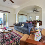 Open-plan living and dining area with traditional furnishings and a view of the pool at Casa Zarah.