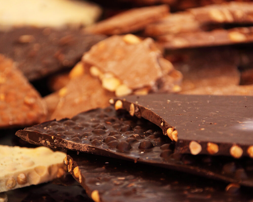 Assorted pieces of dark, milk, and white chocolate with nuts