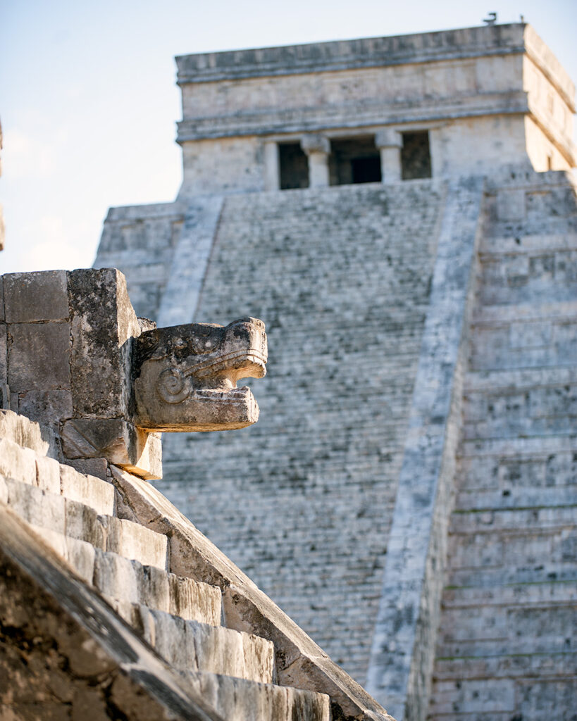 Stone serpent head at base of El Castillo pyramid, Chichén Itzá