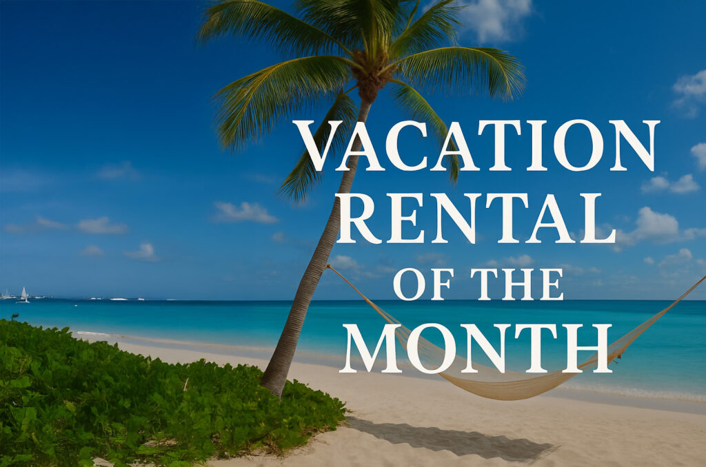Tropical beach with a hammock between palm trees, clear blue skies, and white clouds. Overlaid text reads “Vacation Rental of the Month.”