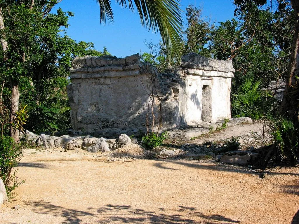 Restored colonial-era chapel surrounded by tropical vegetation at Xcaret.