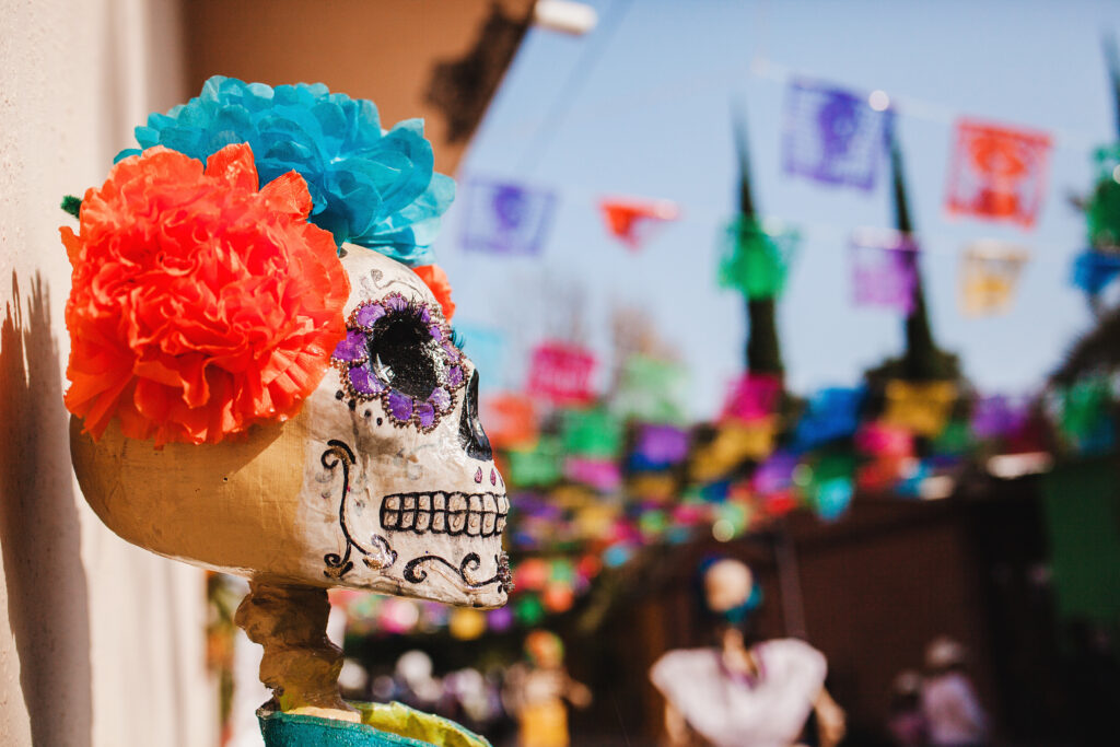 Decorative Catrina skull with colorful flowers during Día de Muertos celebrations in Puerto Morelos.