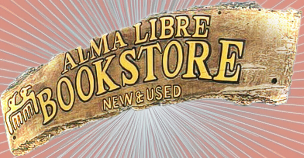 Close-up of the rustic “Alma Libre Bookstore” sign with “New & Used” beneath it.