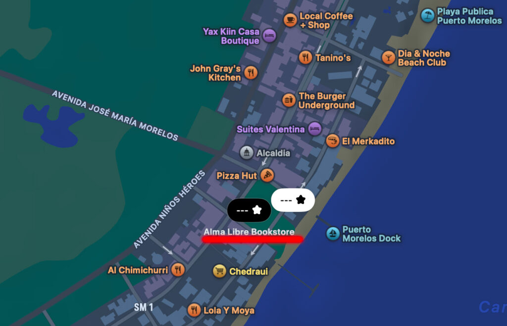 Map of Puerto Morelos showing the location pin for Alma Libre Books & Gifts near the town center by the main plaza.