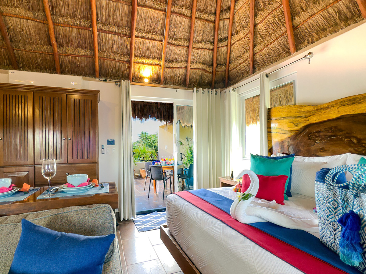 Bright studio interior at Casa Catalina 3 with palapa ceiling and tropical accents in Puerto Morelos
