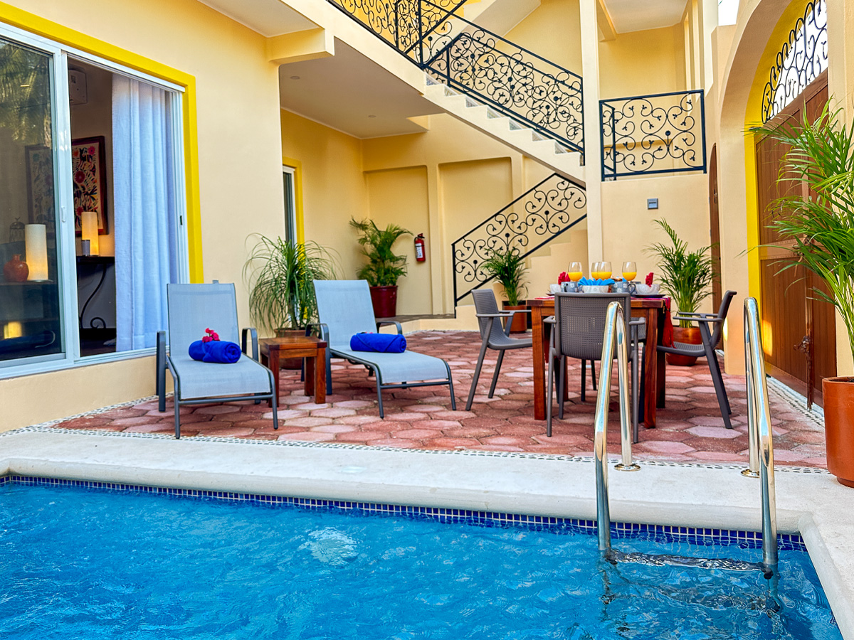Pool and patio seating area at Casa Catalina in Puerto Morelos
