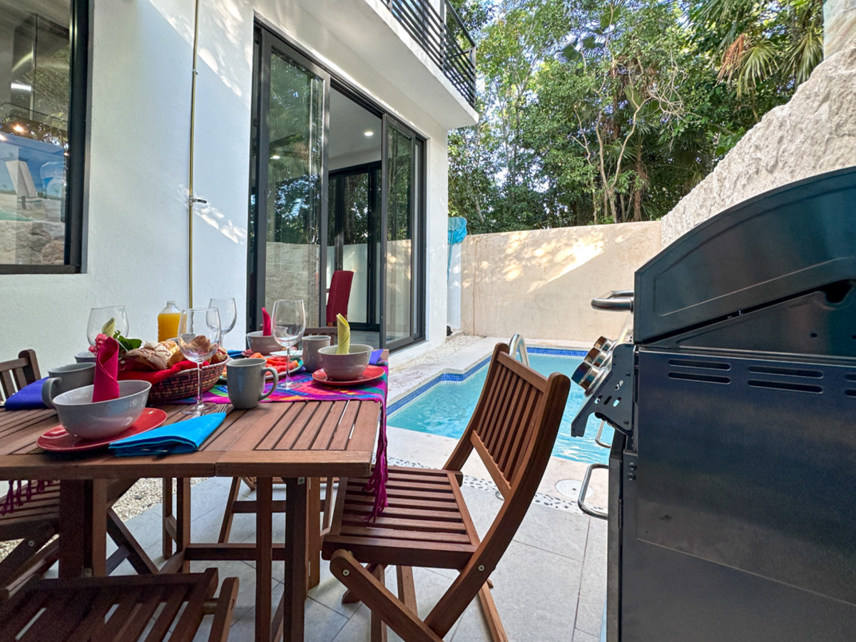 Outdoor dining patio at Casa Debra surrounded by a peaceful tropical setting in Aldea Ha