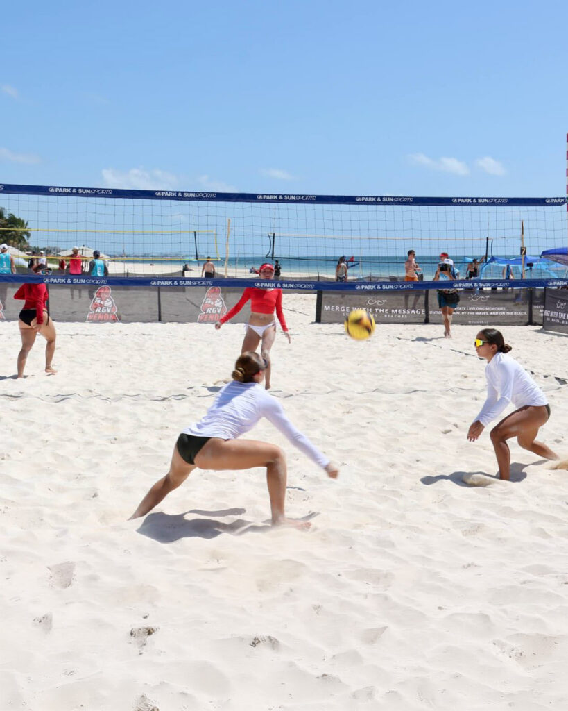Beach volleyball players compete on the sand in Puerto Morelos.