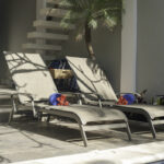 Lounge chairs on the shaded patio at Casa Agua Azul beside the pool.