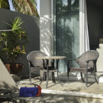 Small patio table at Casa Agua Azul with chairs and tropical plants nearby.