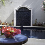 Private pool at Casa Agua Azul with flowers and shaded patio details.
