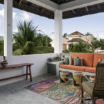 Covered terrace at Casa Agua Azul with colorful seating and neighborhood views.