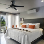 Bright bedroom at Casa Agua Azul with king bed and balcony doors.