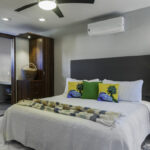Bedroom at Casa Agua Azul with king bed, ceiling fan, and air conditioning.