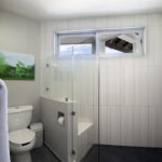 Bright bathroom at Casa Agua Azul with white tile shower.