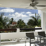 Covered balcony at Casa Agua Azul with Caribbean views and outdoor seating.