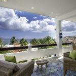 Covered terrace at Casa Agua Azul with lounge seating and Caribbean views.