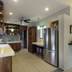 Kitchen and dining area at Casa Agua Azul with wood cabinets and stainless refrigerator.