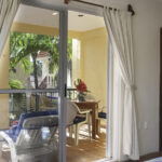 Balcony doors in Apartment A#10 opening from the bedroom to private outdoor seating.