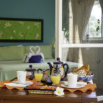 Breakfast tray on the private balcony at Apartment A#10 with a view into the bedroom.