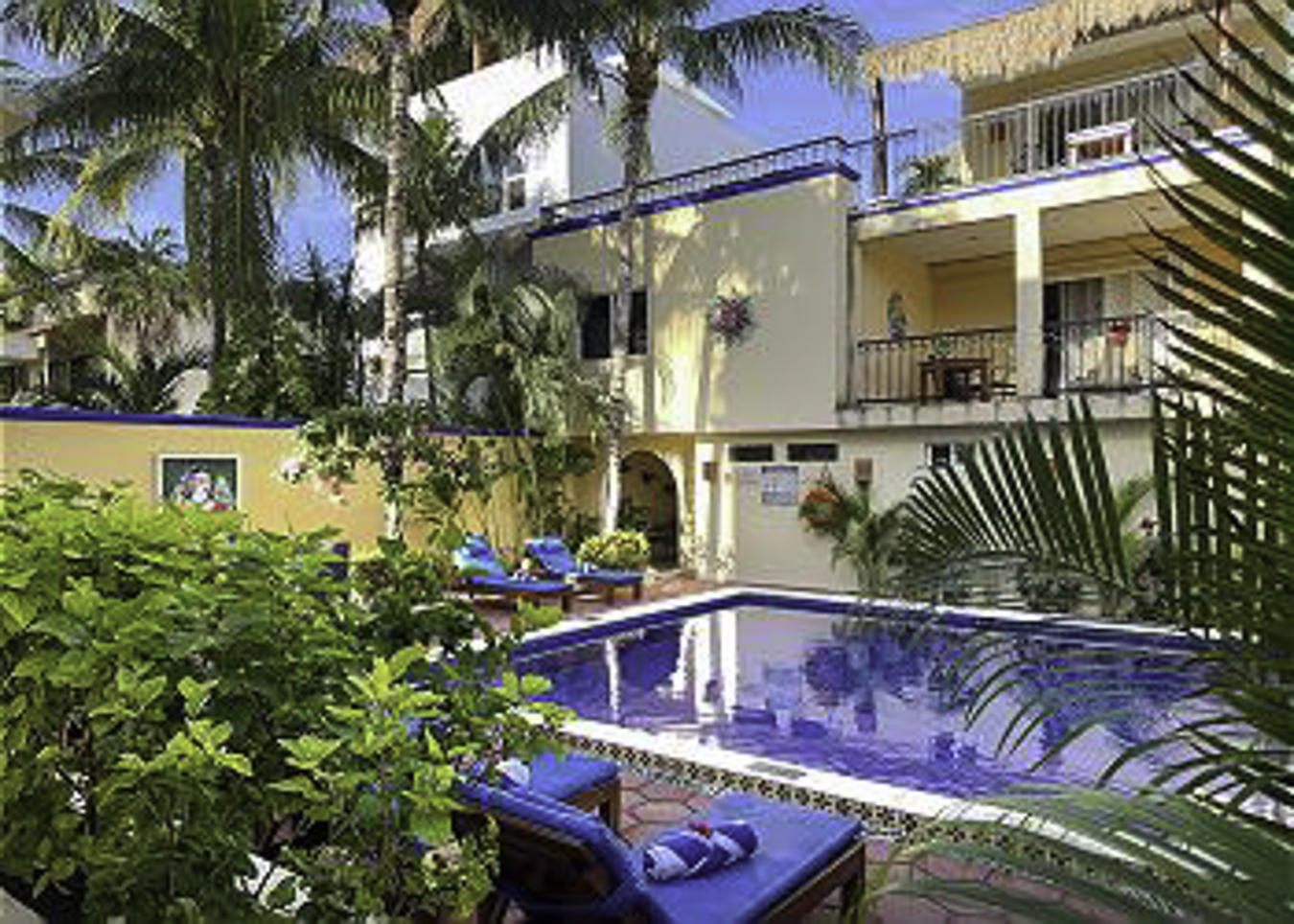 Pool and garden at Abbey del Sol with Apartment A#10 balcony above.
