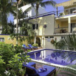 Pool and garden at Abbey del Sol with Apartment A#10 balcony above.