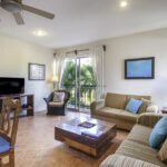 Bright living area in Apartment A#10 with sofa, dining table, and full kitchen.