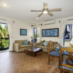 Open living and dining area in Apartment A#10 with large windows and balcony access.