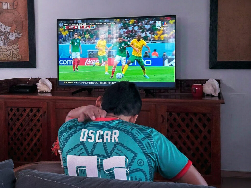 Abbey del Sol staff member watching a World Cup soccer game on TV.