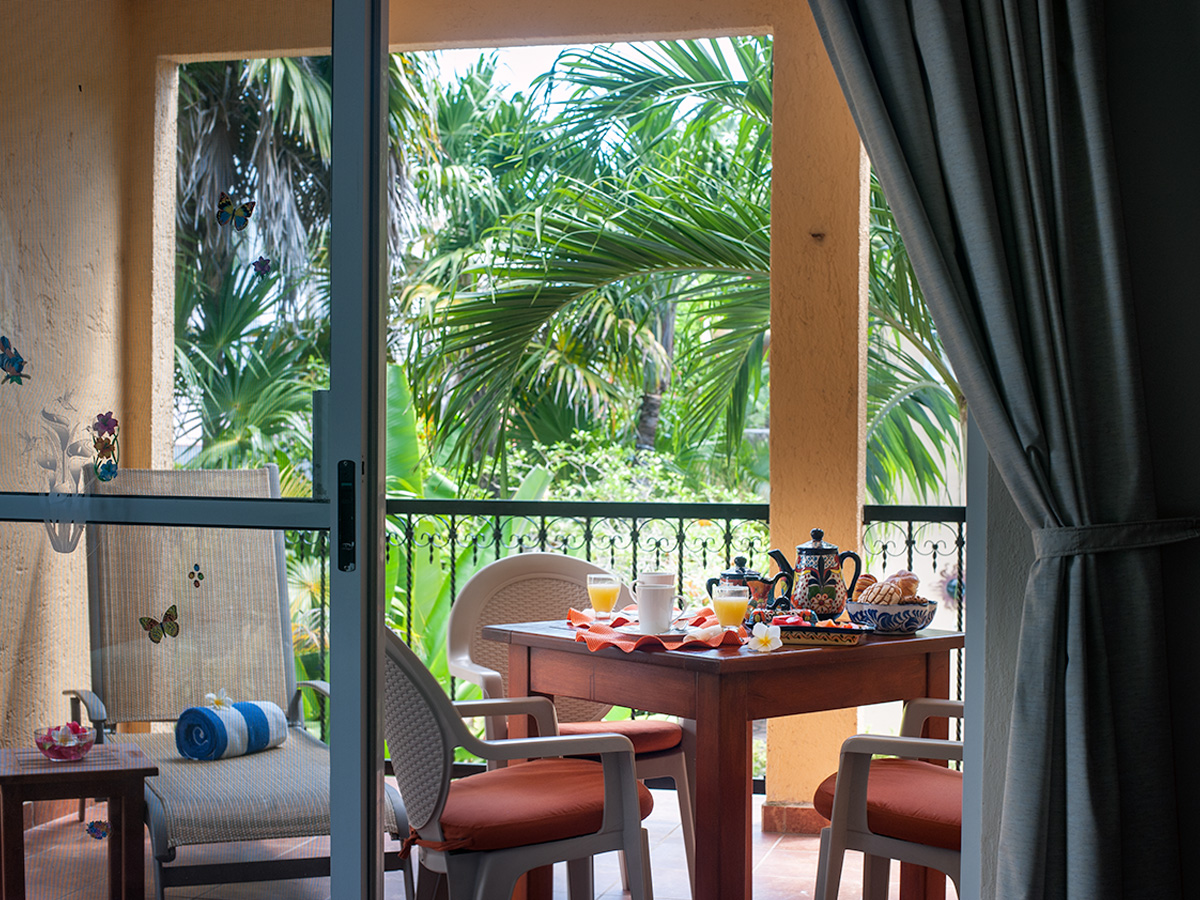 View from Apartment A#10 toward the private balcony and tropical garden.