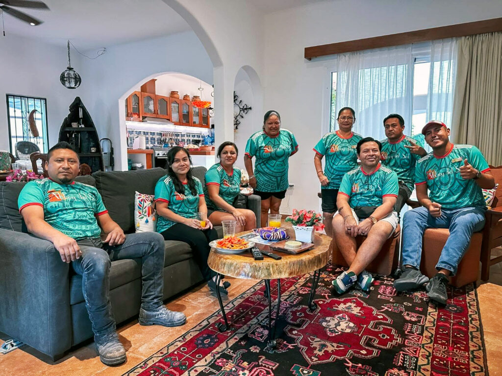 Abbey del Sol staff sitting together in green shirts while watching the World Cup opening game.