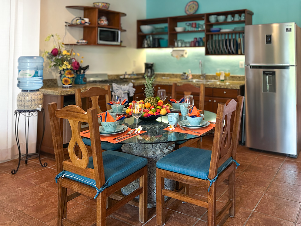 Colorful dining table and full kitchen in Apartment #10 at Abbey del Sol 2.