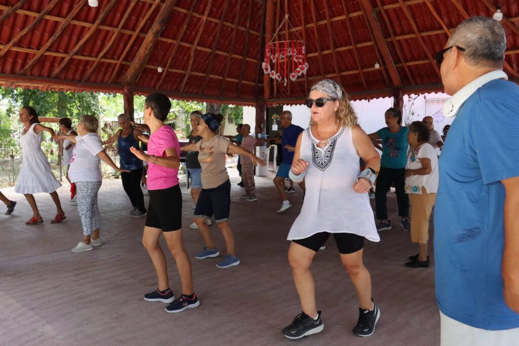 Older adults moving together during an exercise class at Nohoch Uinic