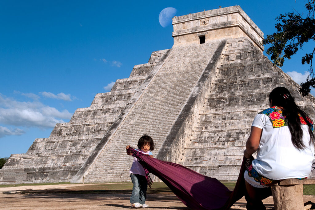 Woman and child in front of El Castillo at Chichén Itzá