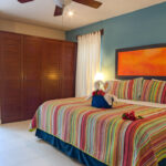 King bedroom with patio access and wooden wardrobe in Abbey del Sol Apartment #8