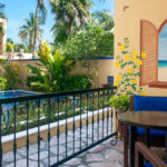 Private patio overlooking the pool and tropical garden at Abbey del Sol Apartment #8