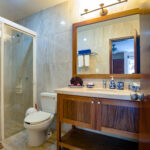 Bathroom with walk-in shower and wooden vanity in Abbey del Sol Apartment #8