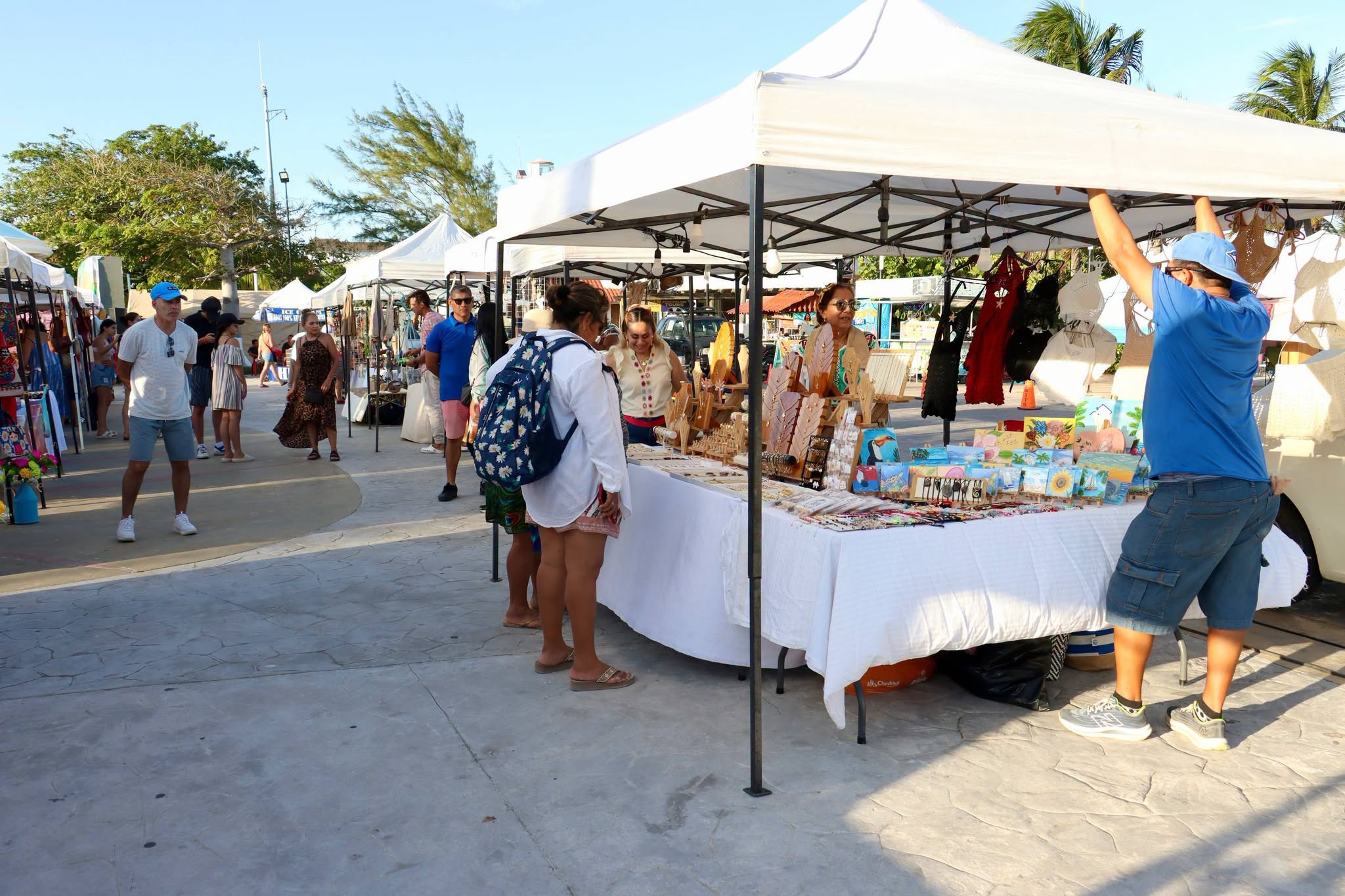 Visitors browse handmade art and crafts at the Puerto Morelos fair