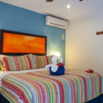 King bedroom with television and patio access in Abbey del Sol Apartment #8