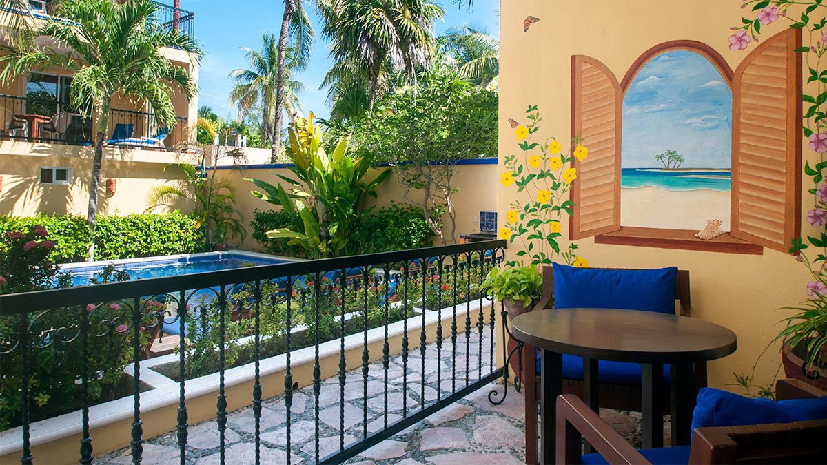 Private patio overlooking the pool and tropical garden at Abbey del Sol Apartment #8
